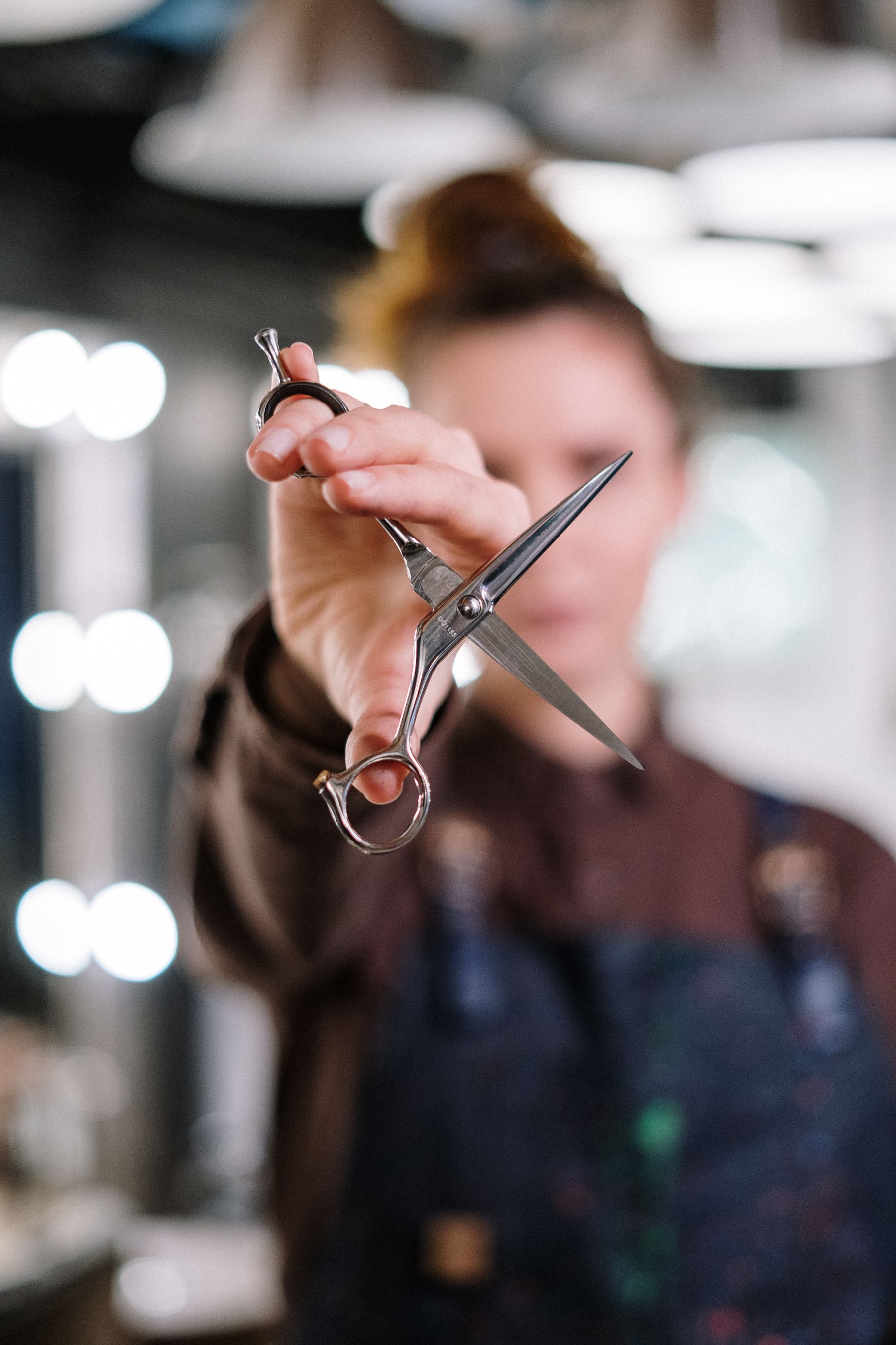 Stylist holding scissors in a salon